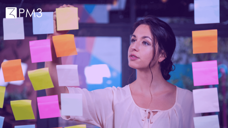 A imagem mostra uma mulher organizando post-its em um quadro, construindo o roadmap de produto